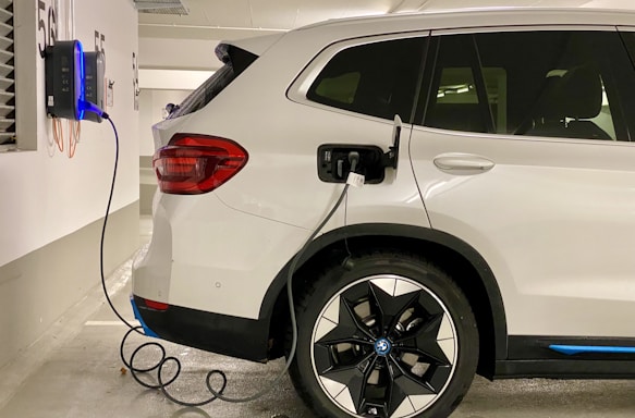 an electric car plugged in to a charging station
