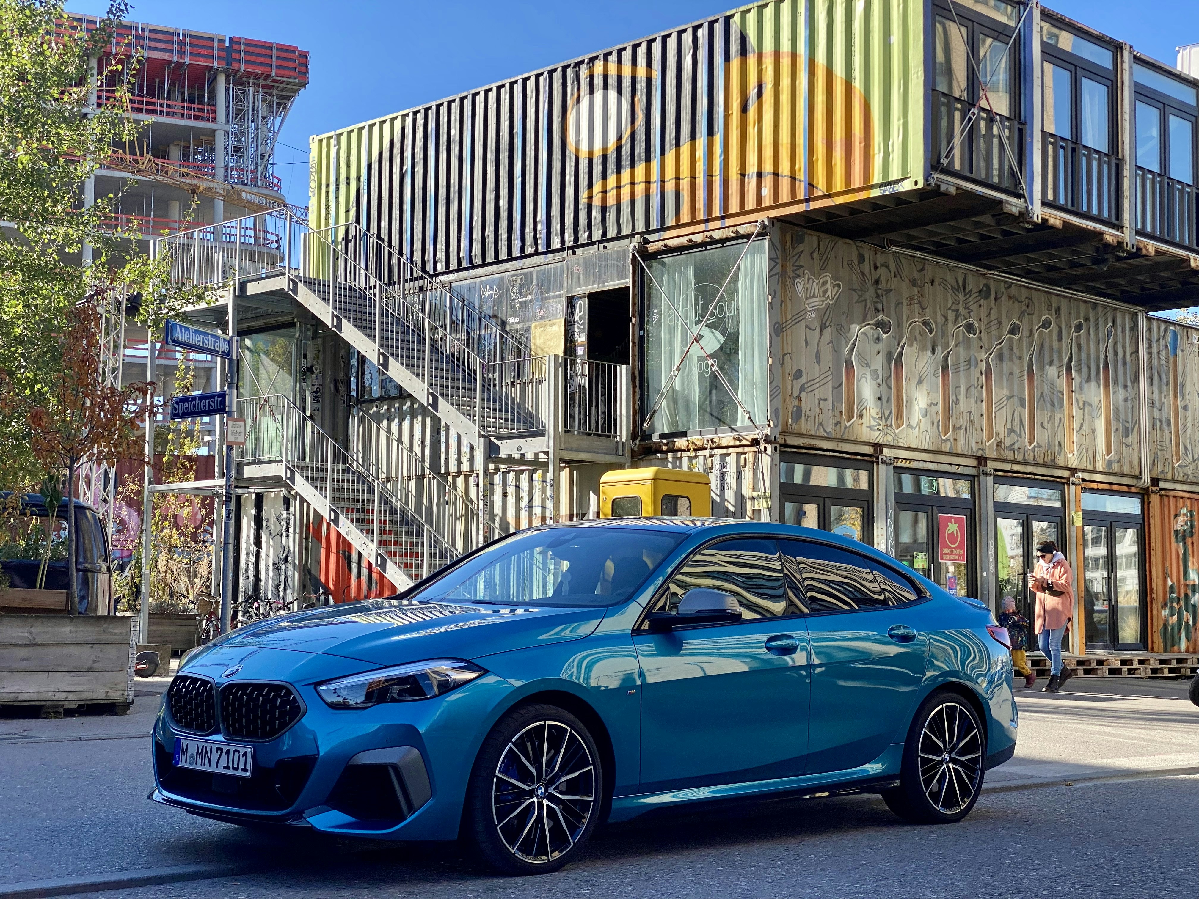 a blue car parked in front of a building