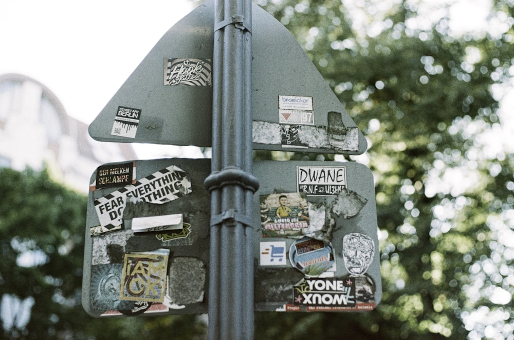 a pole with a bunch of stickers on it