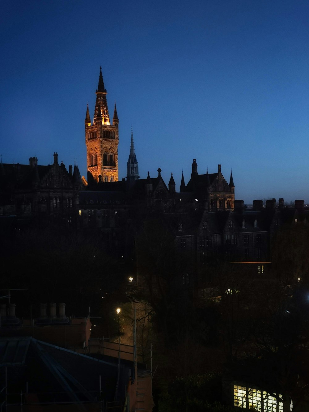 a large clock tower towering over a city at night