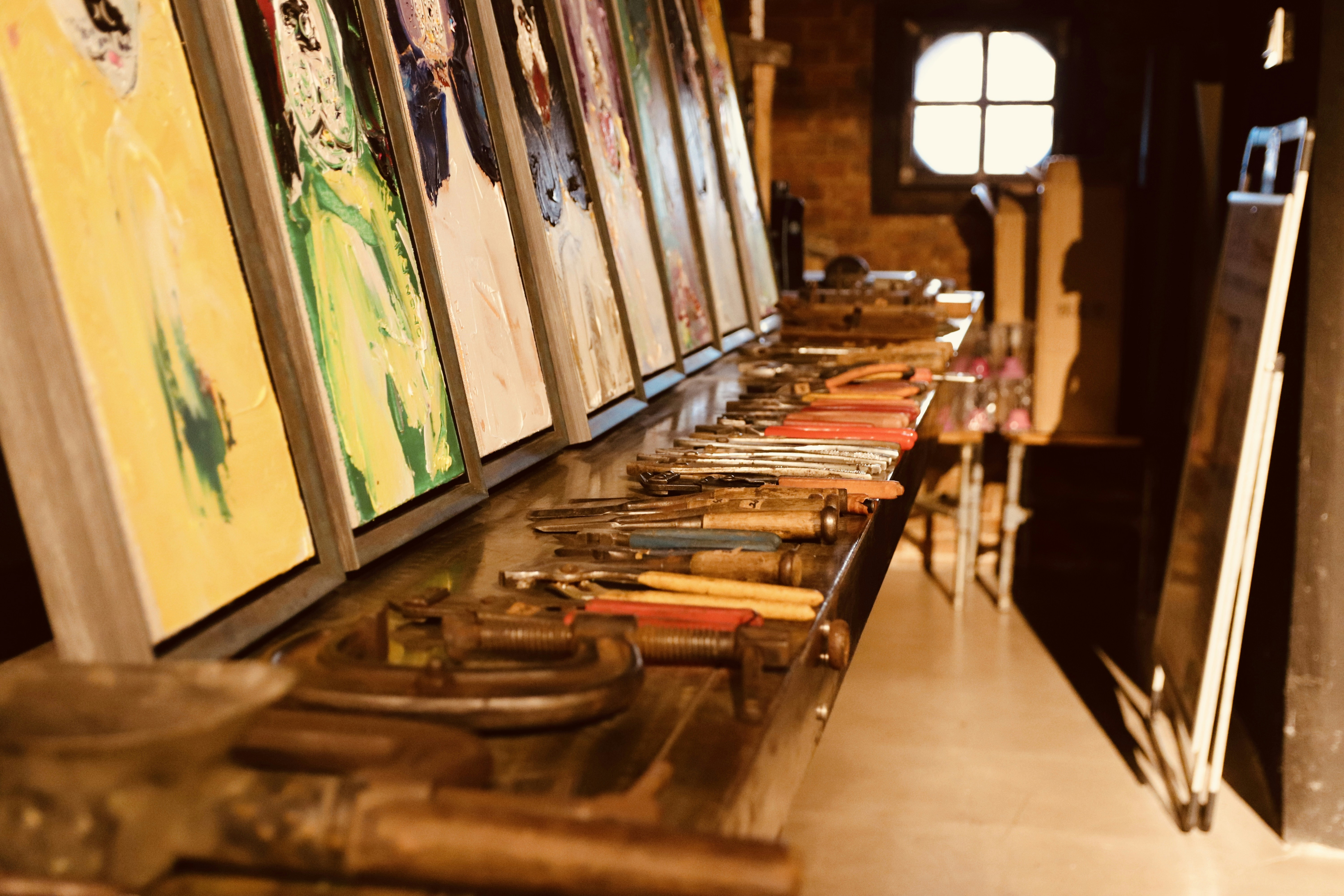 a row of framed pictures sitting on top of a table