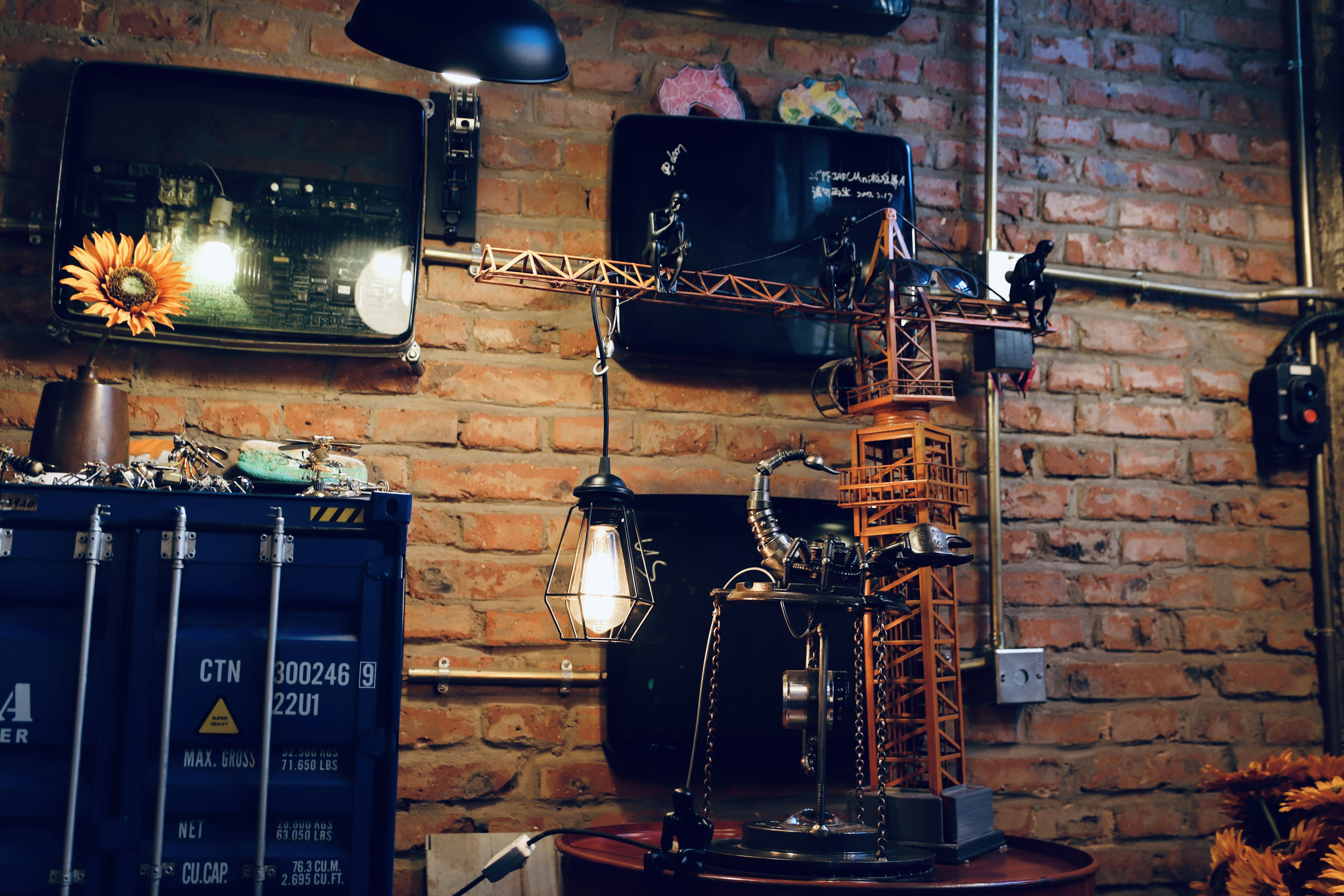 a room with a brick wall and a clock on the wall