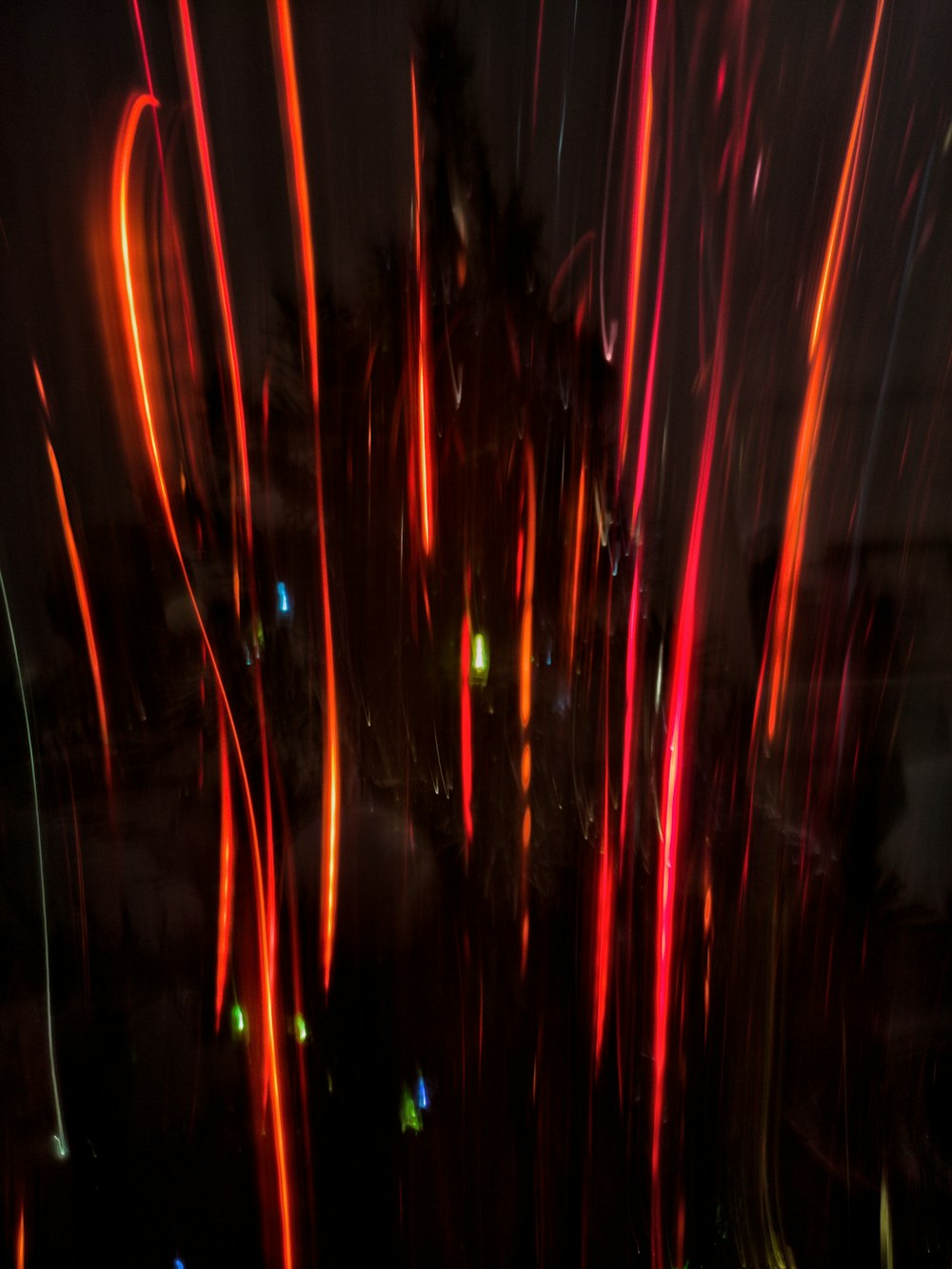 a blurry photo of fireworks in the night sky
