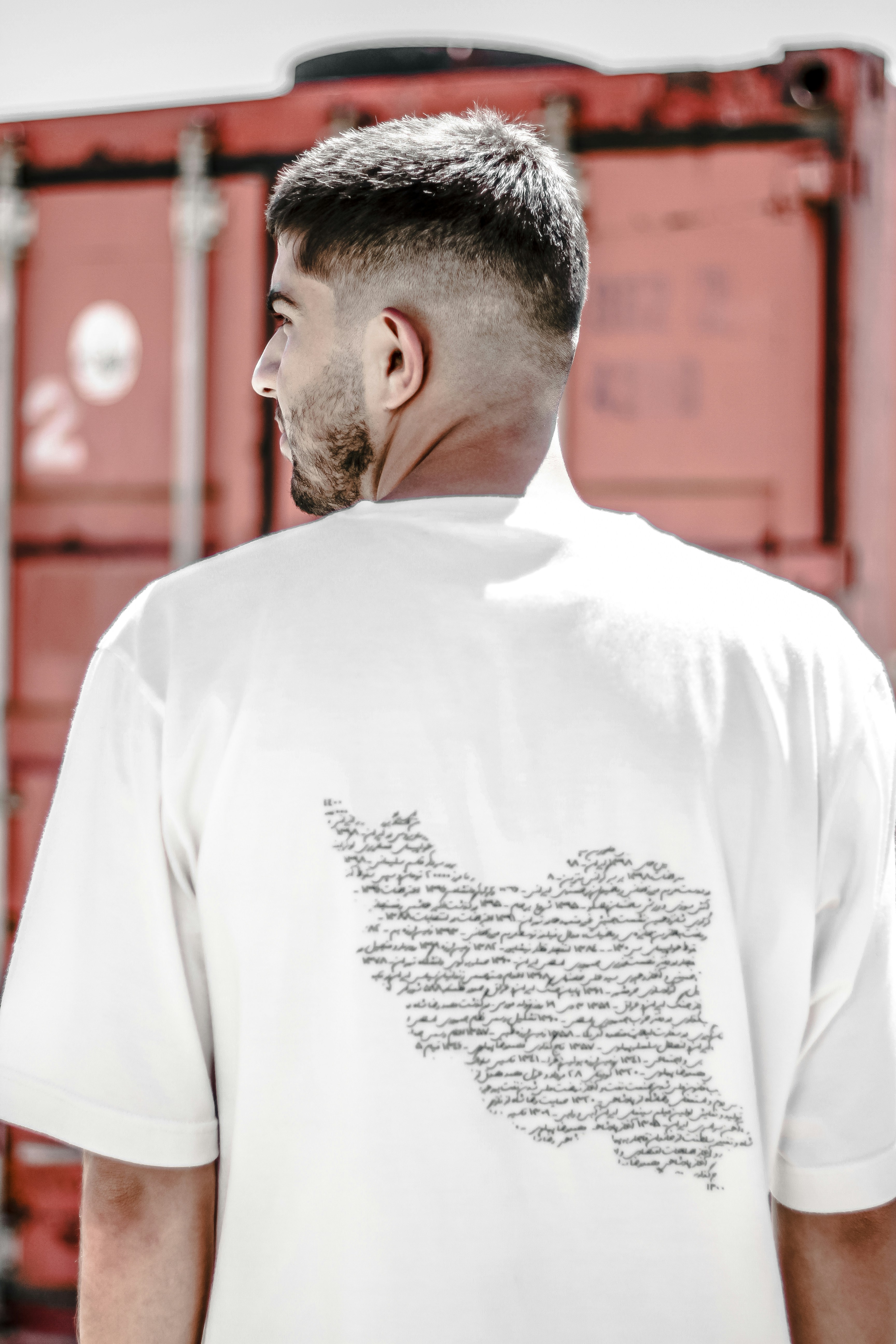 a man standing in front of a train with his back to the camera