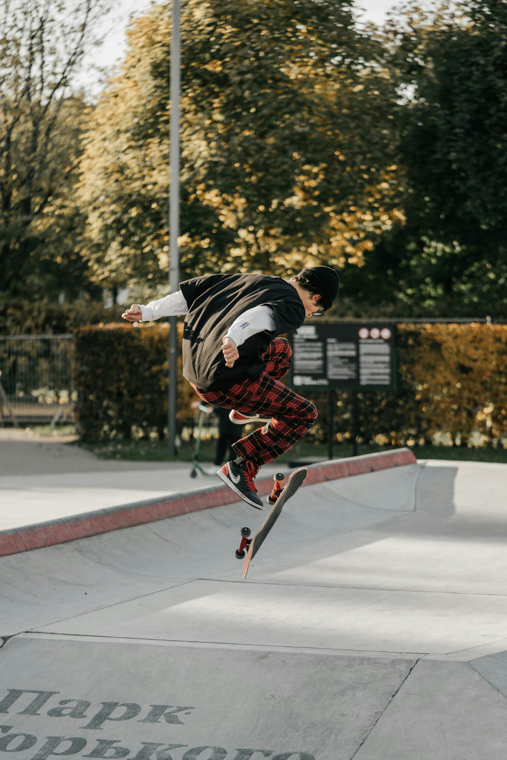 a man jumping in the air doing a trick on a skateboard