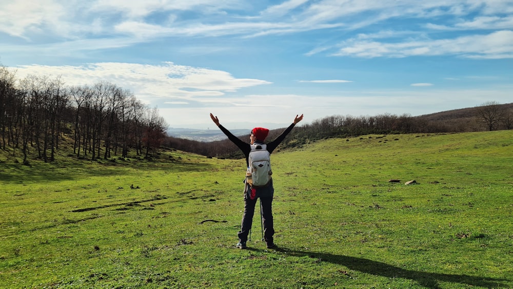 a man standing on top of a lush green field