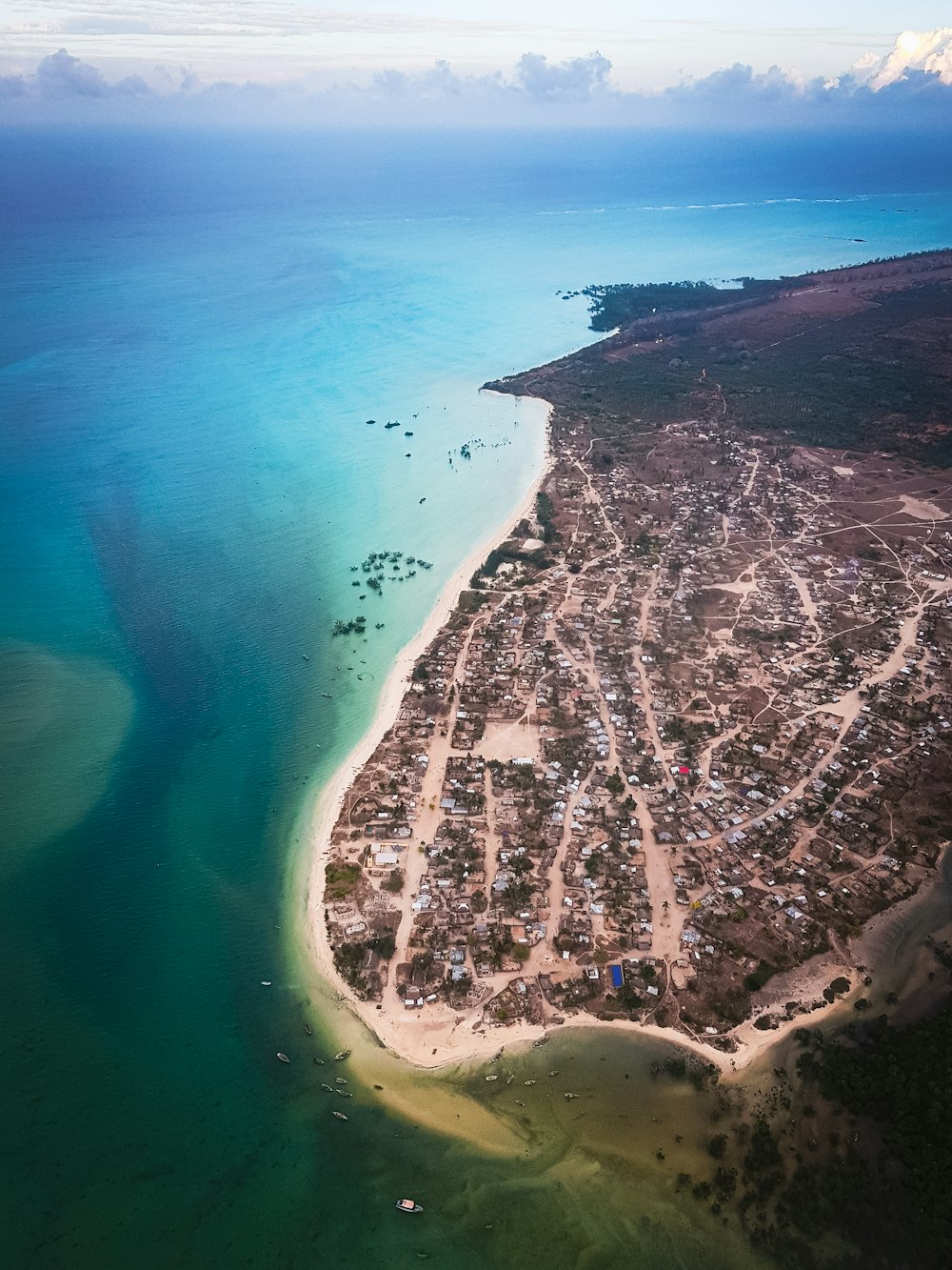 an aerial view of a small town on a beach