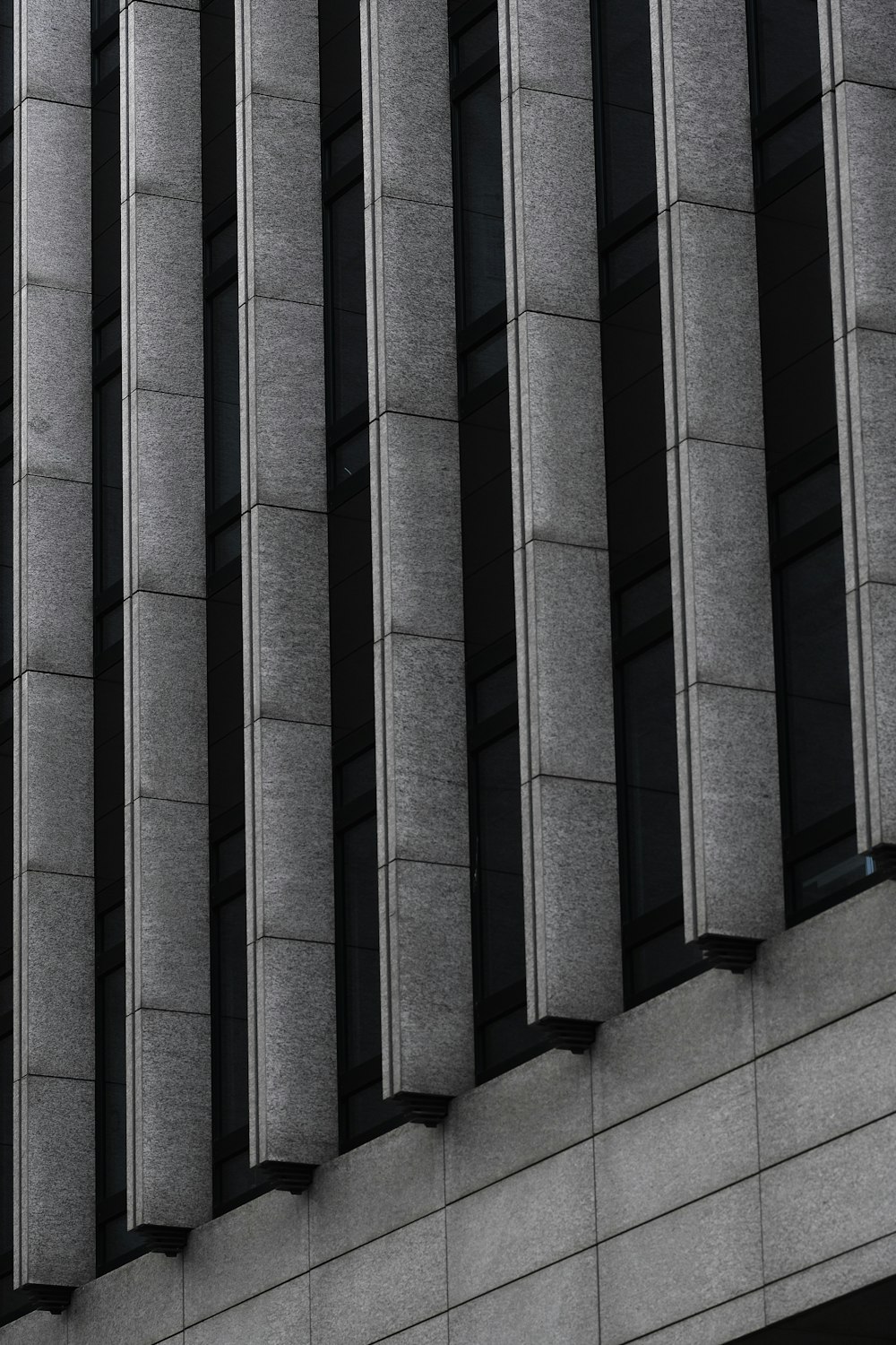 a black and white photo of a clock on the side of a building