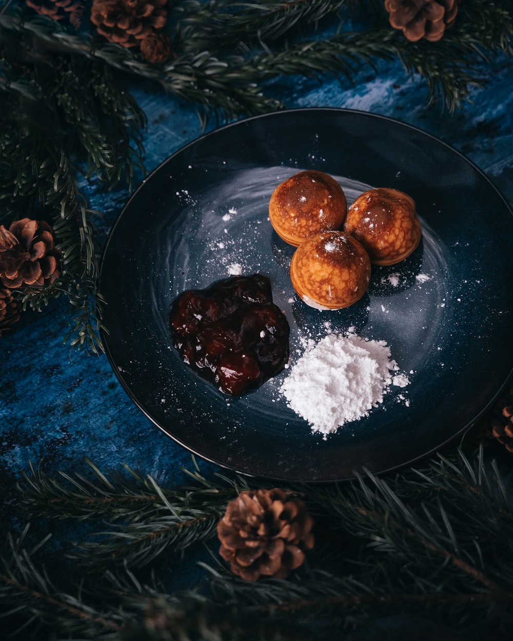 a plate of food on a table with pine cones