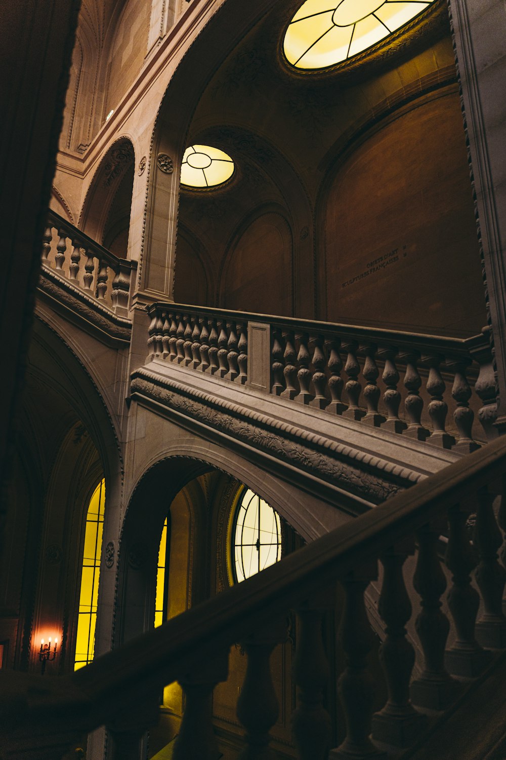a staircase in a building with stained glass windows