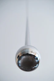 Close-up of a shiny, precisely spun metal reflector used in industrial lighting.