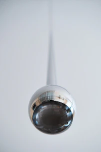 Close-up of a shiny, precisely spun metal reflector used in industrial lighting.