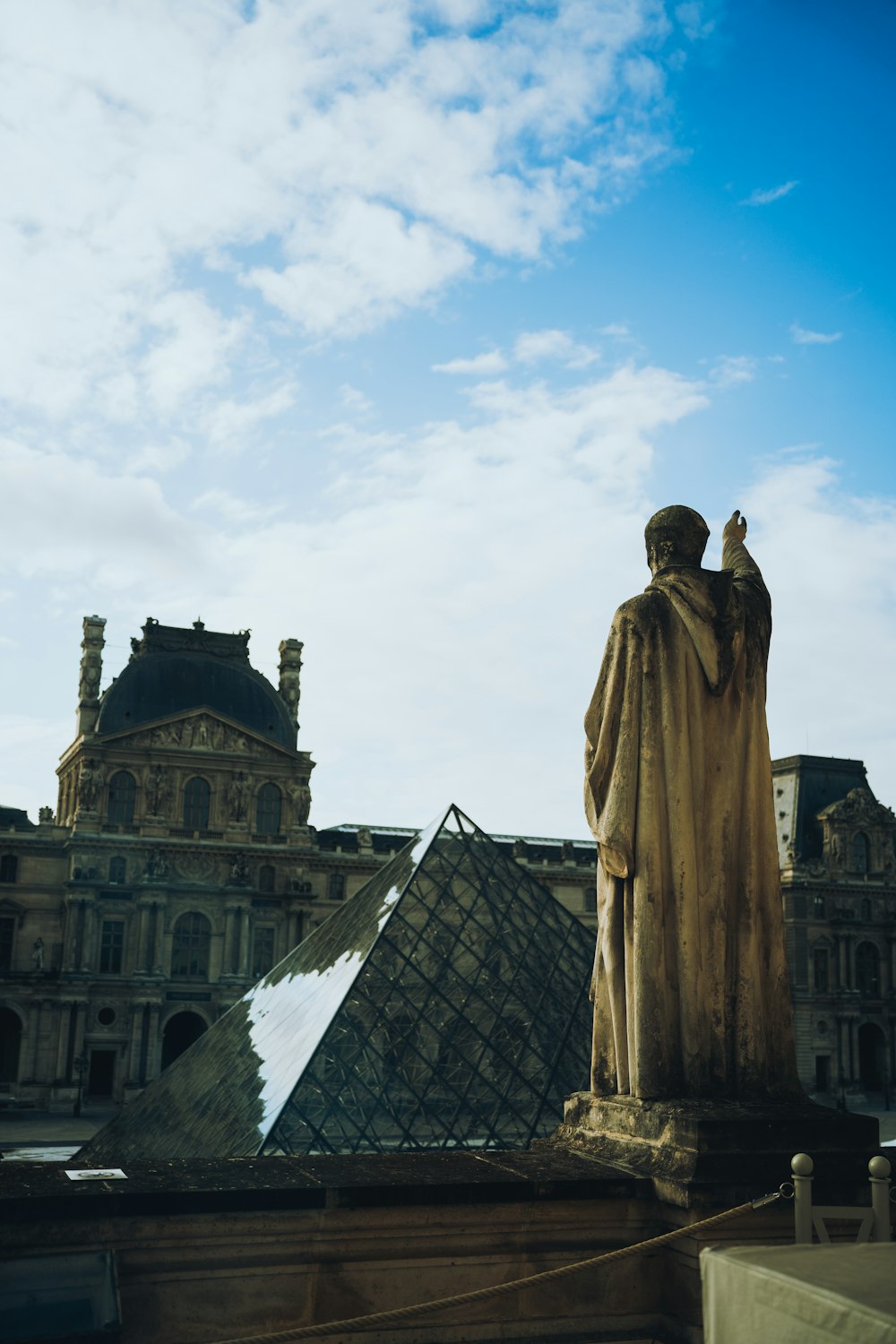 a statue of a man standing in front of a building