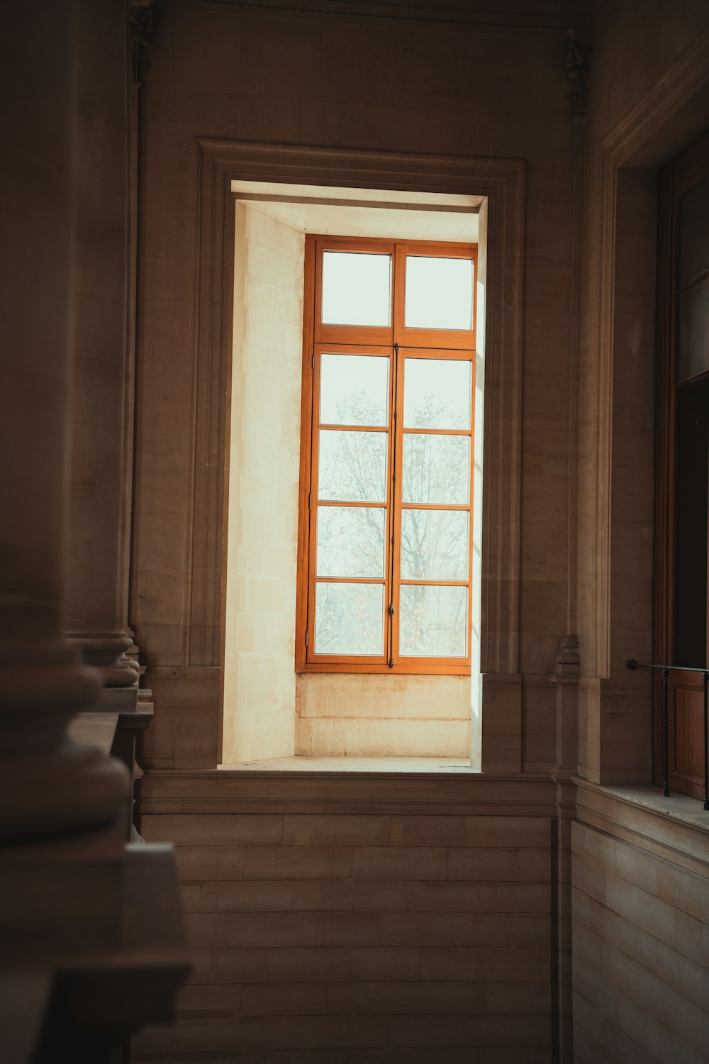 a window in a building with a tree outside