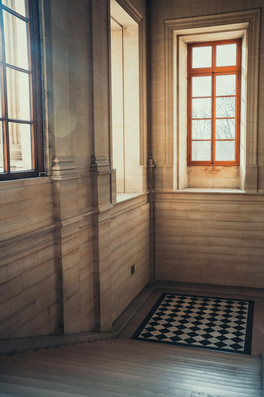 a room with a checkered floor and a window