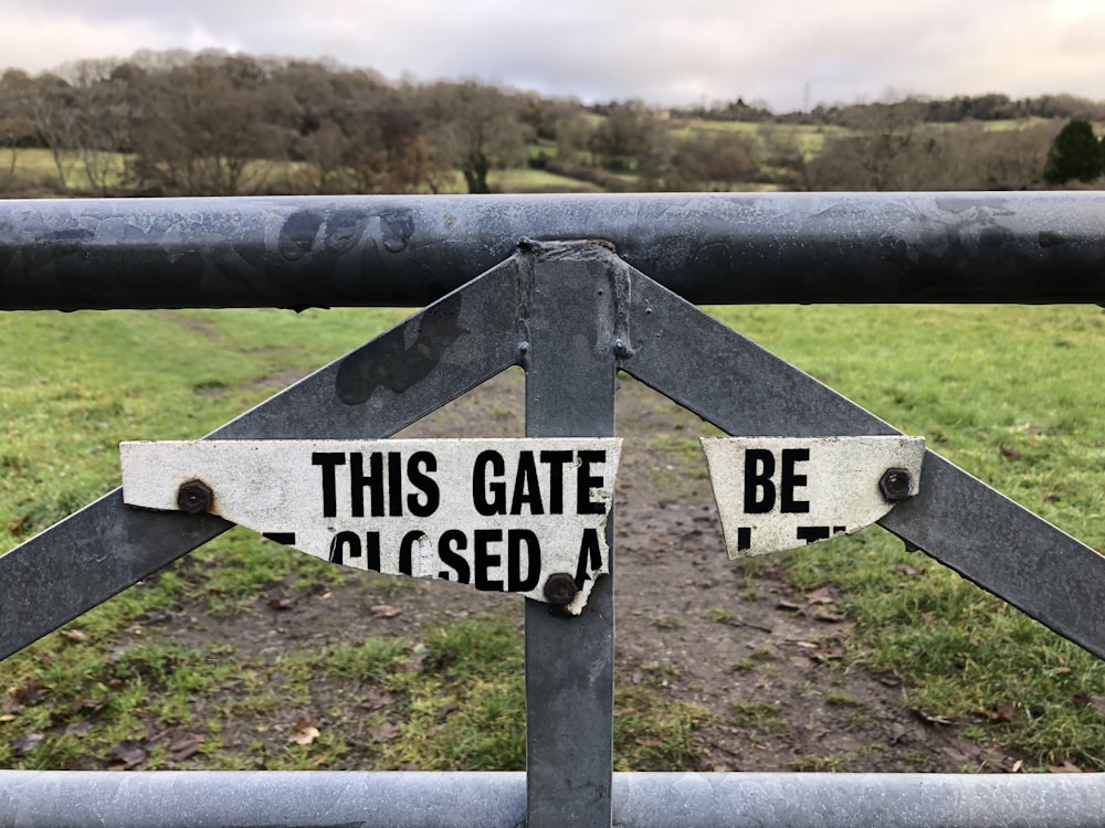 a gate with a sign that says this gate is closed