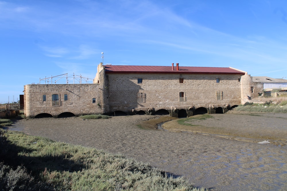 an old brick building with a red roof