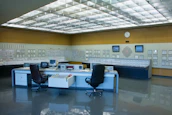 A control room with multiple monitors tracking infrastructure and security systems.