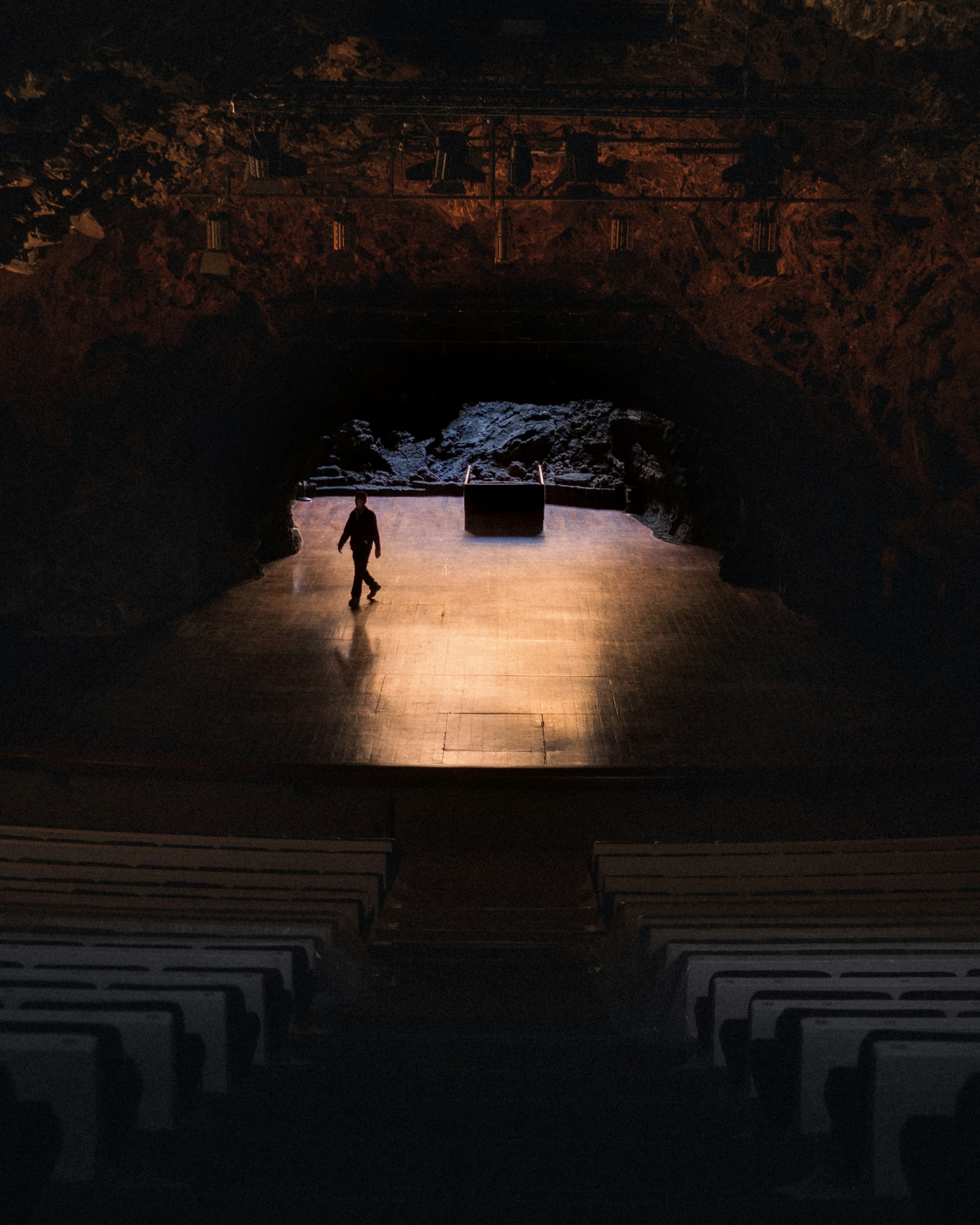 a person standing on a stage in the dark