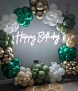 A vibrant balloon arch framing a joyful birthday party scene.