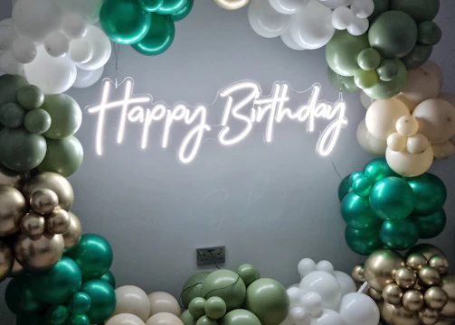 A vibrant balloon arch framing a joyful birthday party scene.