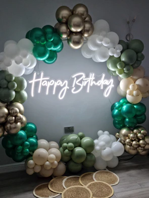 An elegant balloon arch decorating a festive birthday party setup in a cozy home.