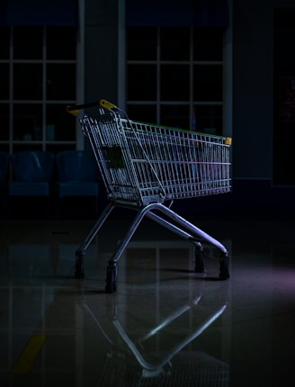 a shopping cart sitting on the floor in a dark room