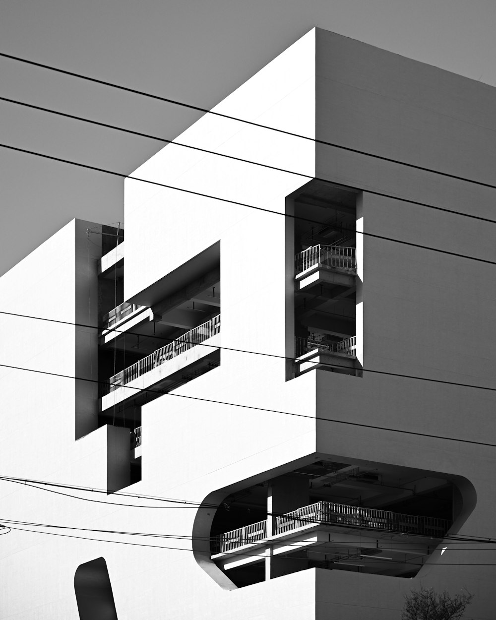 a black and white photo of a building with balconies