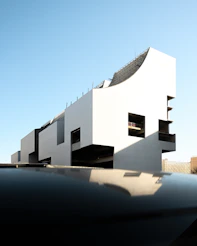 a white building with black balconies on top of it