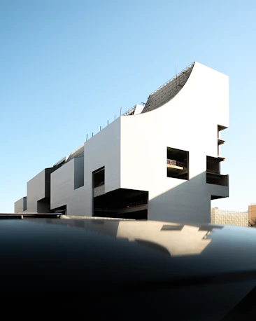 a white building with black balconies on top of it