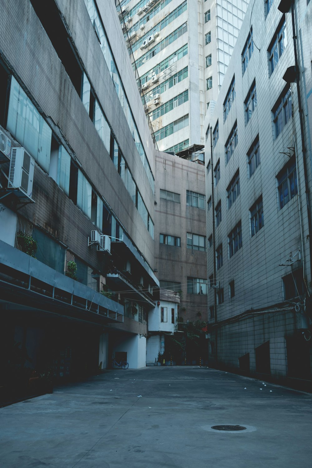 an empty parking lot in front of a tall building