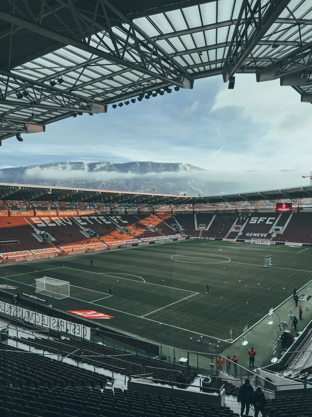 a soccer field with a mountain in the background