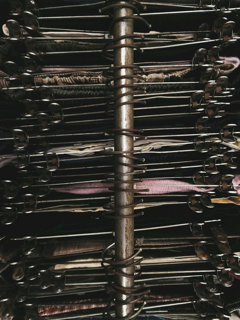 a metal rack filled with lots of different types of ties