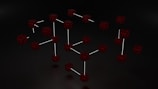 Clusters of interconnected cubes with a dark, web-like texture are set against a black background, with some cubes connected by thin white lines.