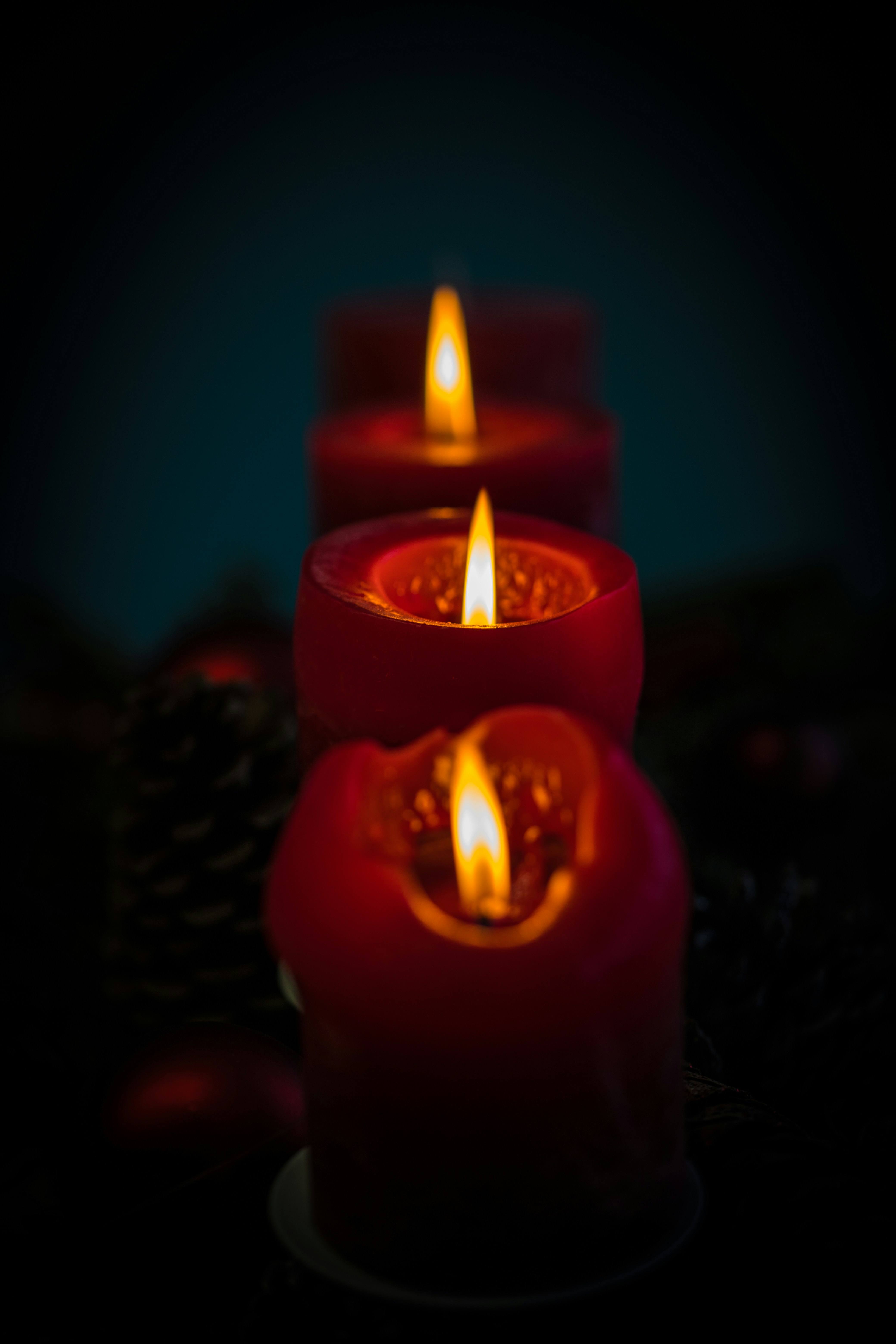 a group of lit candles sitting on top of a table