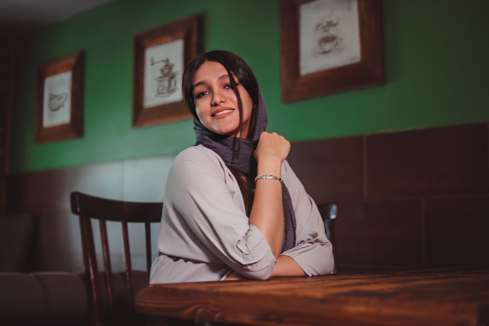 a woman sitting at a table in a restaurant