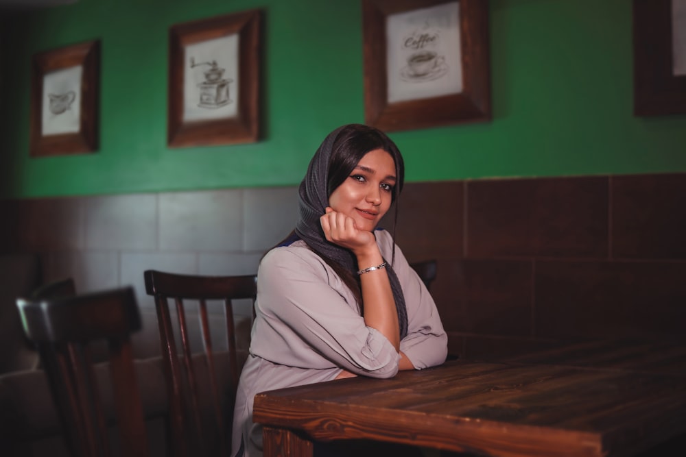 a woman sitting at a table in a restaurant