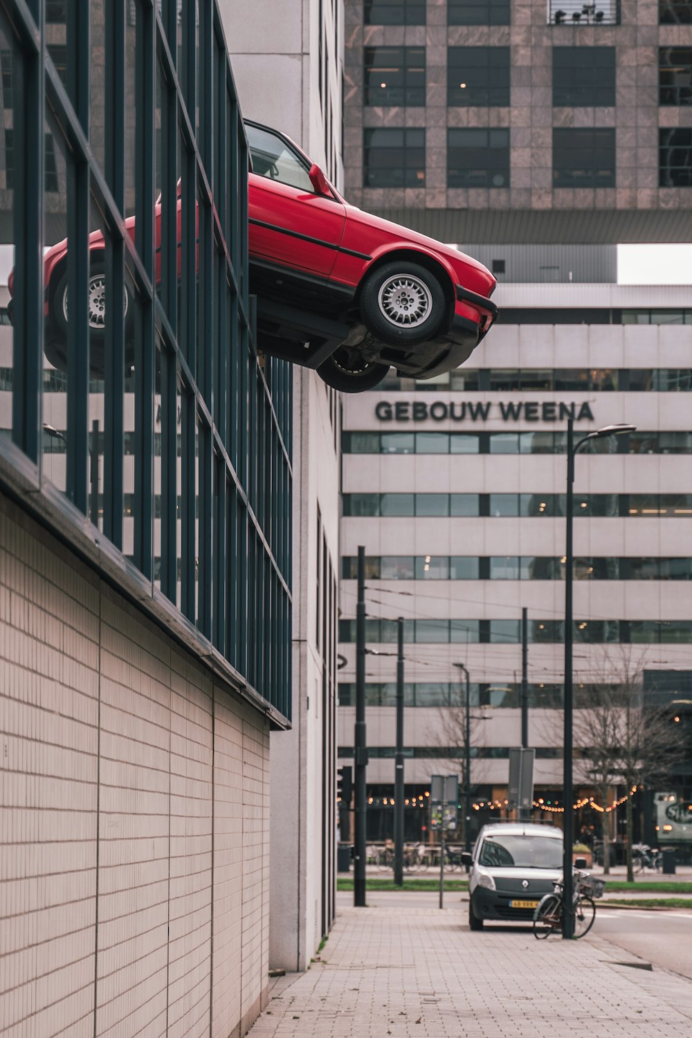 a car is upside down on the side of a building