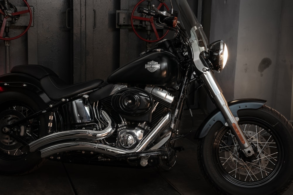 a black motorcycle is parked in a garage