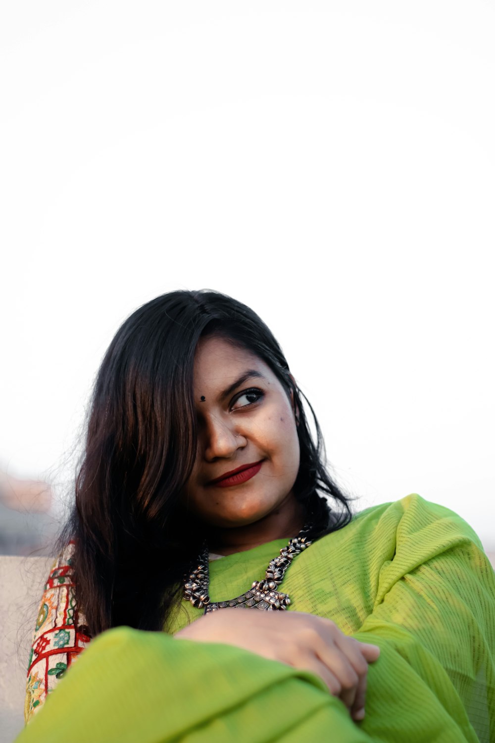 a woman in a green sari poses for a picture