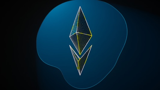 A geometric design consisting of two three-dimensional kite-shaped polygons stacked vertically against a gradient blue background. The shapes have thin outlines with a neon yellow tint, creating a modern and digital appearance.
