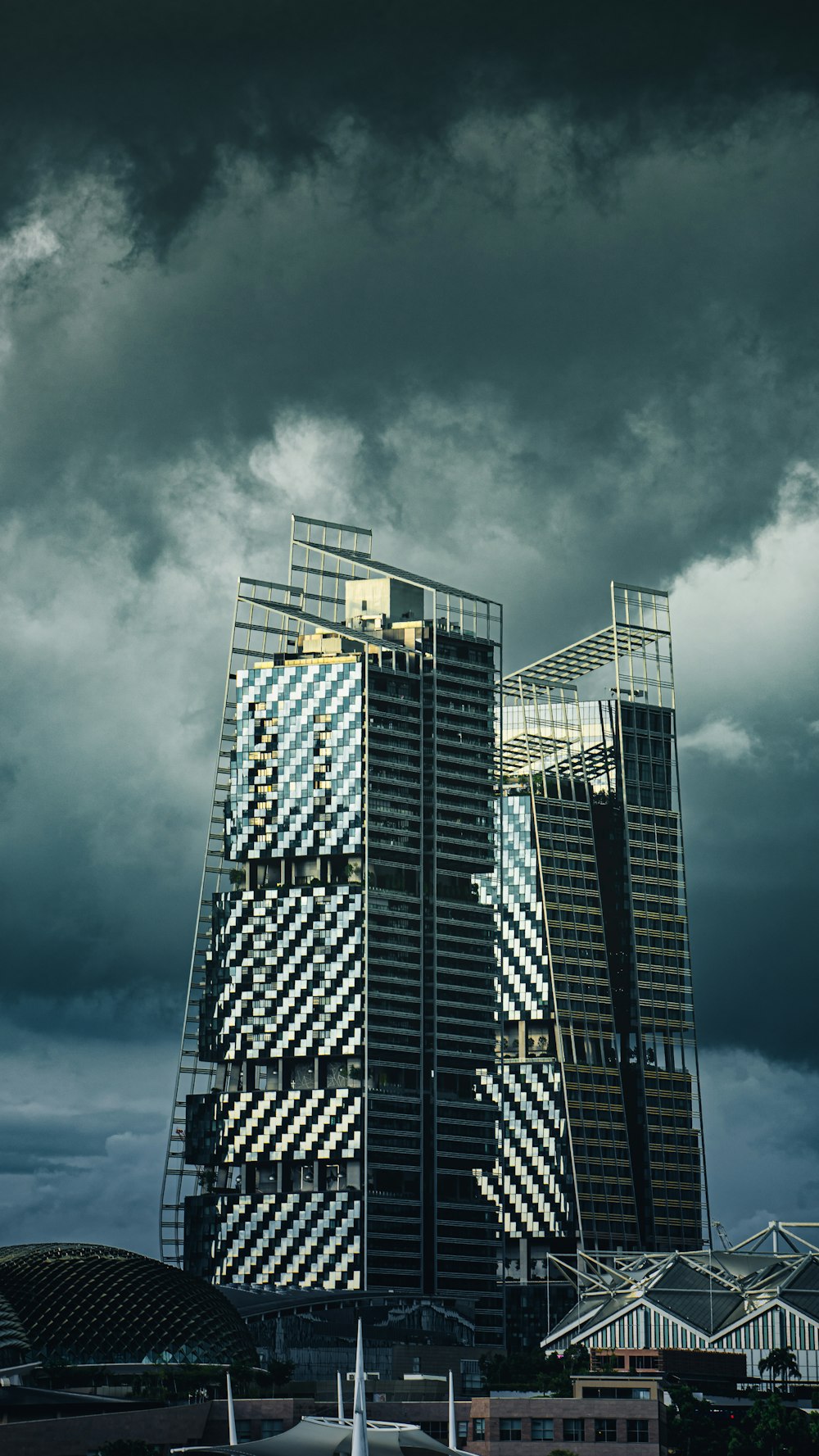 a very tall building sitting under a cloudy sky