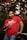 a man in a red shirt holding a wine glass