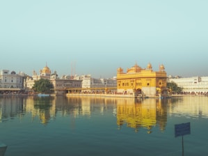 A peaceful temple courtyard adorned with lotus flowers and soft golden light.