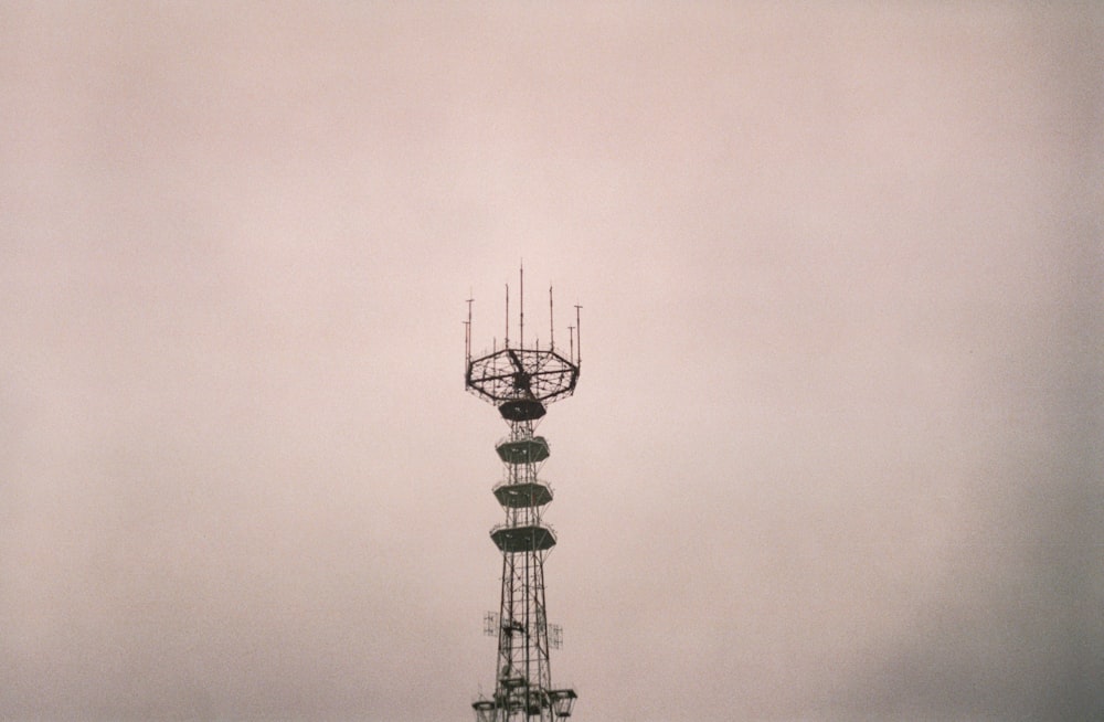 a tall tower with a satellite dish on top of it