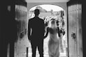 a man and a woman standing in front of a doorway