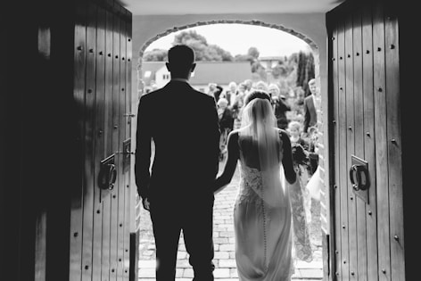 a man and a woman standing in front of a doorway