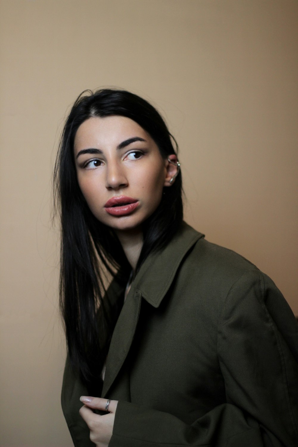 a woman with long black hair is posing for a picture