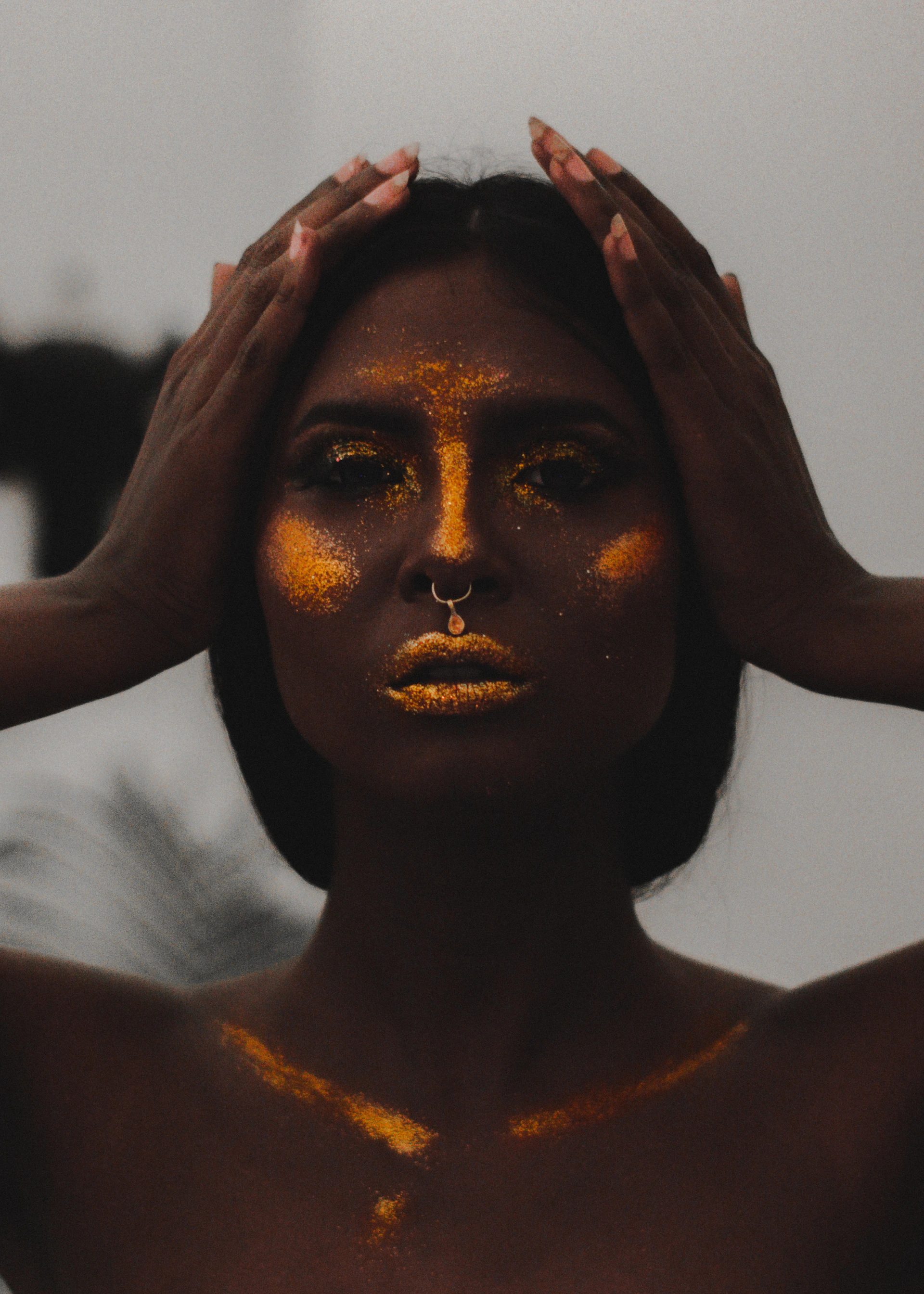 a woman with yellow paint on her face