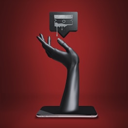 a hand holding a tablet with a tv on top of it